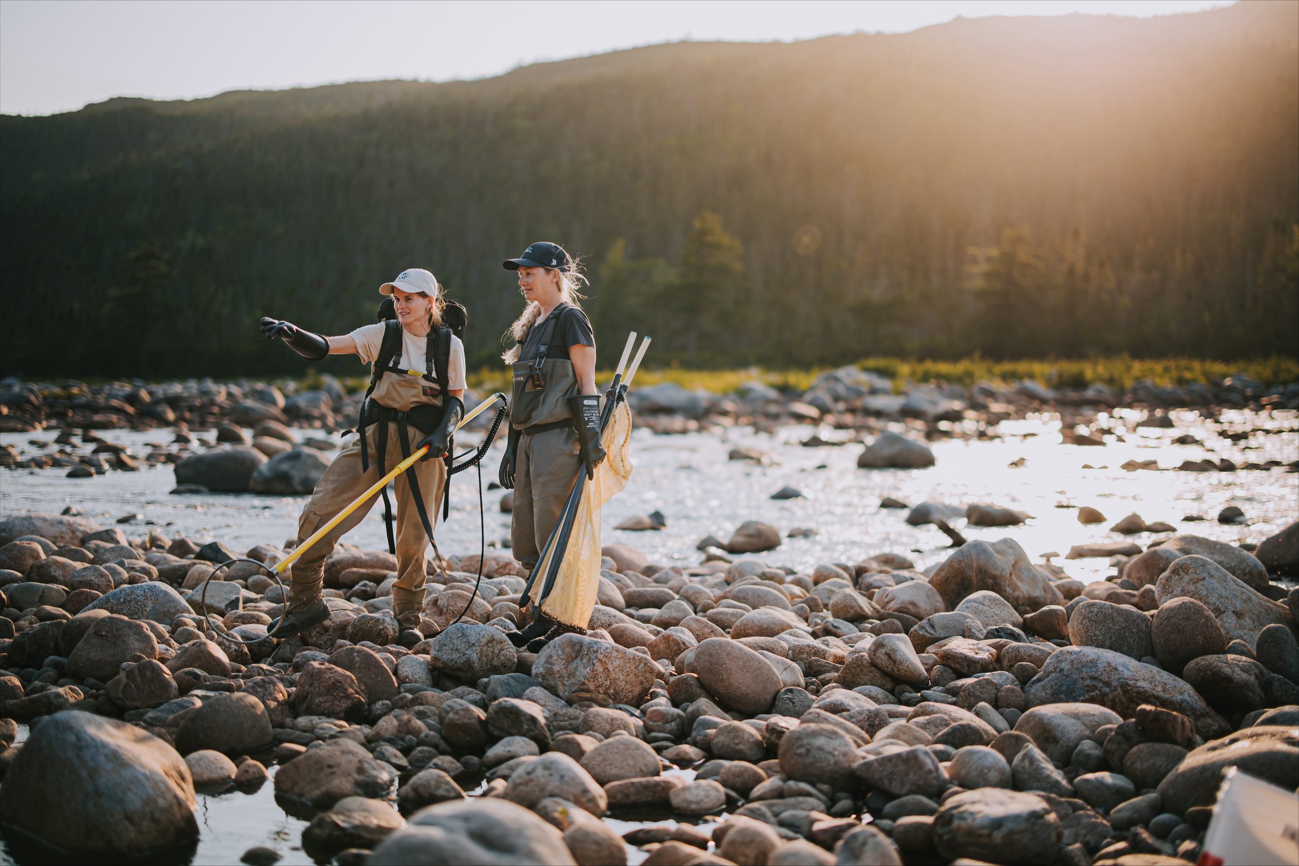 Heather Perry ASF Biologist / Researcher and Kastine Coleman, host of TV series Fishing the Rock, while gathering tissue samples to create genetic profiles of the juvenile Atlantic salmon. Photo by: Dru Kennedy