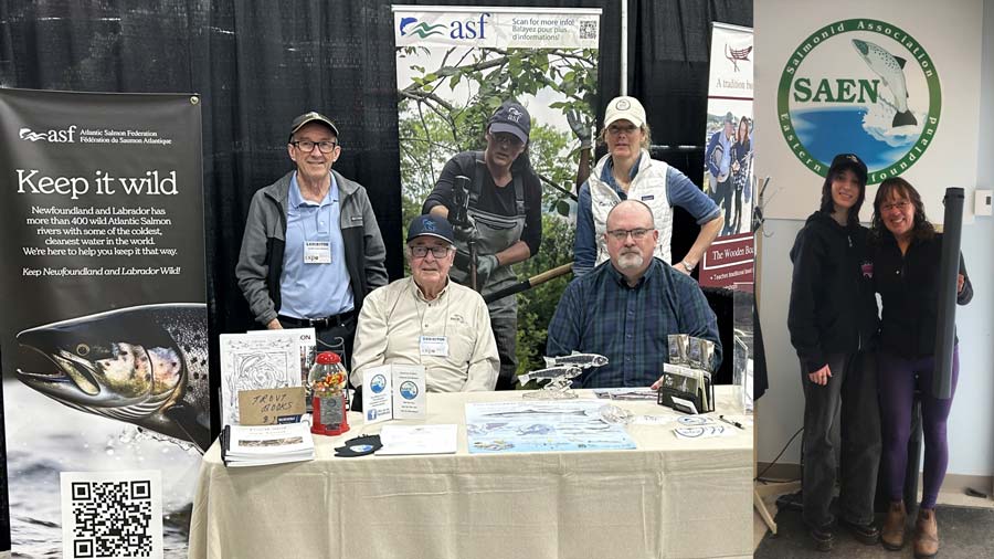 Left: Manning the booth were (l to r) SAEN members Dave Hennessey, Ian Gall, Ian Hutchings and ASF's Kim Thompson. Right: The happy winner of the ASF and SAEN prize draw of a Loop fly rod and SAEN hat was Tracy Lawrence, pictured with her daughter. Photo: Kevin Power.