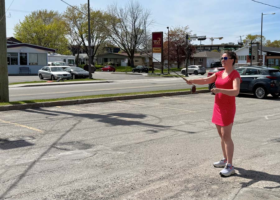 Caroline tests a fly rod in the parking lot of the fly shop in preparation for salmon season. Photo: Caroline Côté