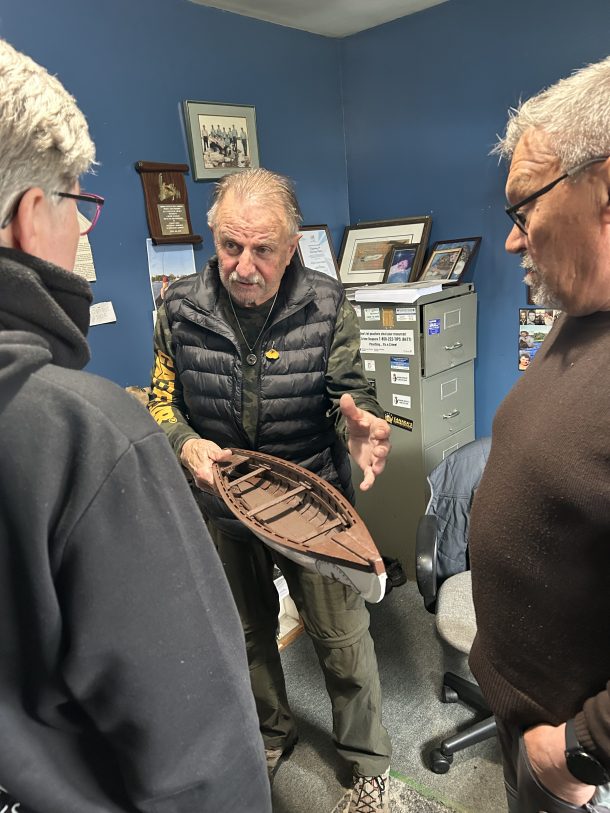 QFN Gander Bay Ward Councillor and Gander Bay Band Chief Calvin Francis explains the famous Gander River boat to Thora Herrman, Oulu University Finland and Elder Jan Erik Henriksen UiT, Photo credit: Kim Thompson