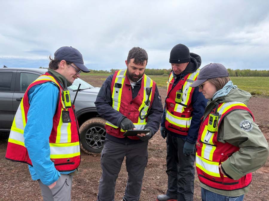 Maxime Lapierre (middle left) from FlytBox Aerial Solutions reviews flight procedures and protocols with ASF flight crew, (from left) Aaron Clausen, Graham Chafe, and Kate Gingles. Photo: Kris Hunter